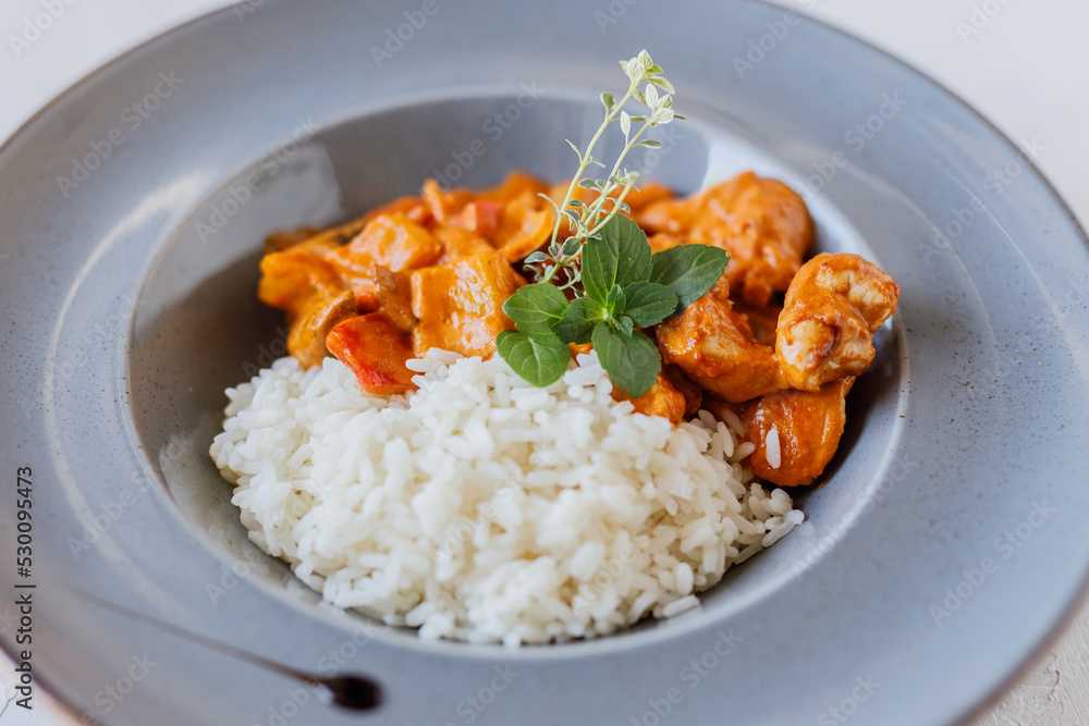 Indian Butter chicken with basmati rice in bowl Indian Butter chicken with basmati rice in bowl