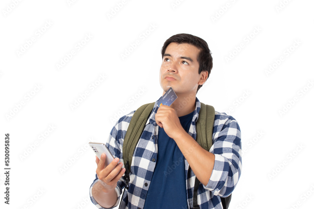 Portrait of cheerful young traveler man with backpack isolated on white background. Tourist man looking think holding mobile phone and credit bank card. Portrait of cheerful young traveler man with backpack isolated on white background. Tourist man looking think holding mobile phone and credit bank card.