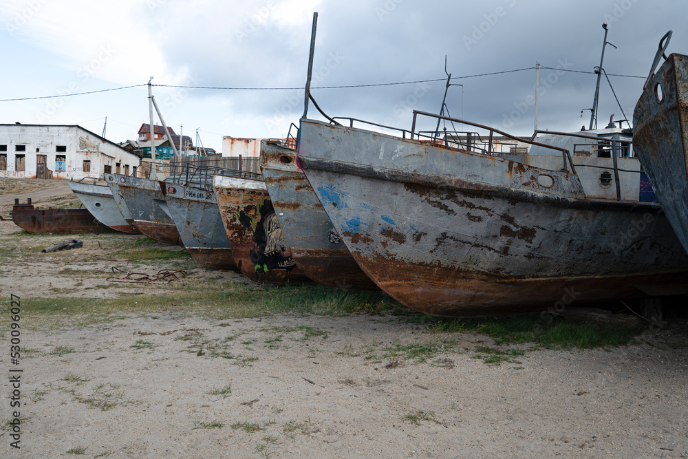 Cemetery of old ships, metal rusty fishing boats on baikal lake. High quality photo Cemetery of old ships, metal rusty fishing boats on baikal lake. High quality photo
