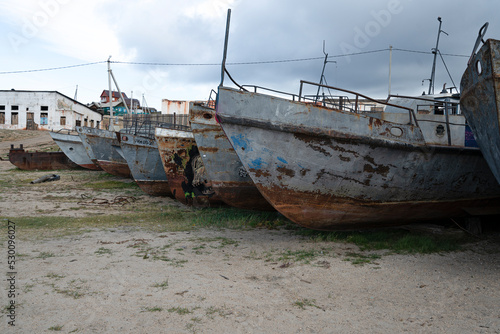 Cemetery of old ships  metal rusty fishing boats on baikal lake. High quality photo