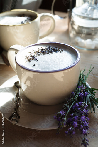 A cup of home made london fog tea latte drink with lavender flower buds, good morning concept, close up.