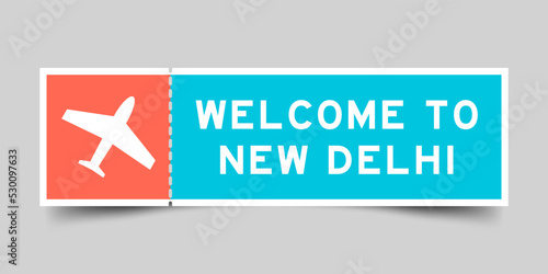 Orange and blue color ticket with plane icon and word welcome to new delhi on gray background