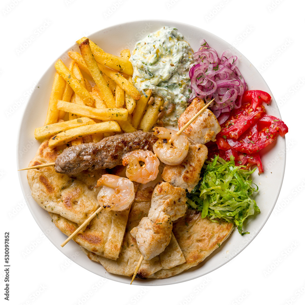 souvlaki with chicken, shrimp kebab and beef lula kebab with french fries, vegetables and pita on white plate isolated on white background top view souvlaki with chicken, shrimp kebab and beef lula kebab with french fries, vegetables and pita on white plate isolated on white background top view