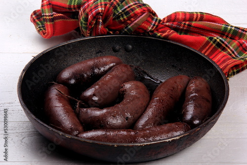 Whole blood sausages on a metal pan,Traditional latvian blood sausages photo