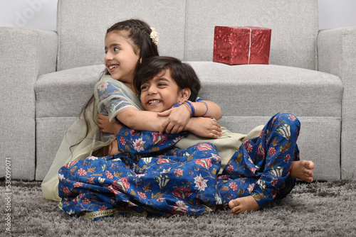 Indian asian cute little kids or siblings celebrating festival 