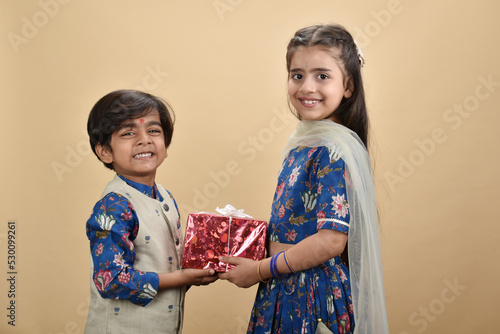 Indian asian cute little kids or siblings celebrating festival 