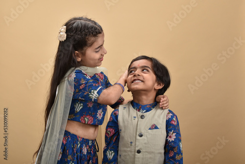 Indian asian cute little kids or siblings celebrating festival 