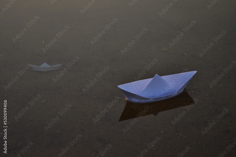 Two paper ship. One of this is sunken. Two paper ship. One of this is sunken.