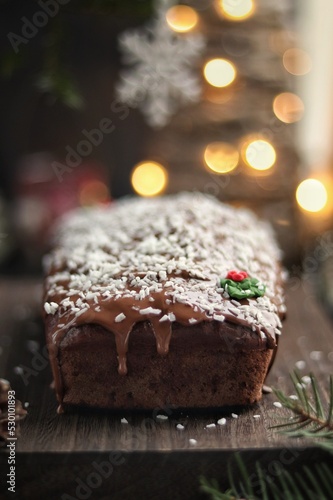 Chocolate cake covered with icing on christmas background