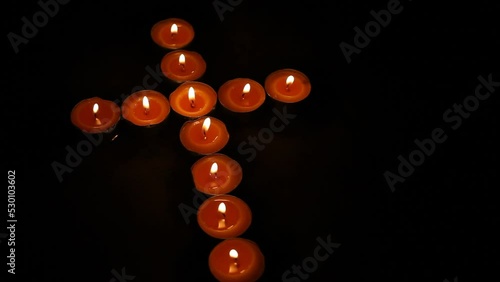 Burning Cross Made of Votive Tea Candles photo