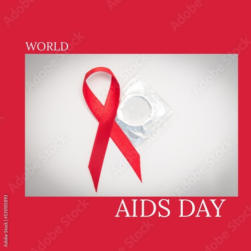 Composition of world aids day text over condom and aids ribbon