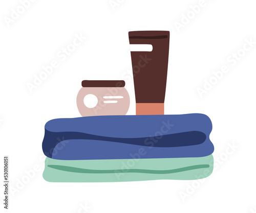 Folded bath towels stack, cream tube, cosmetics jar. Cosmetic products items,...
