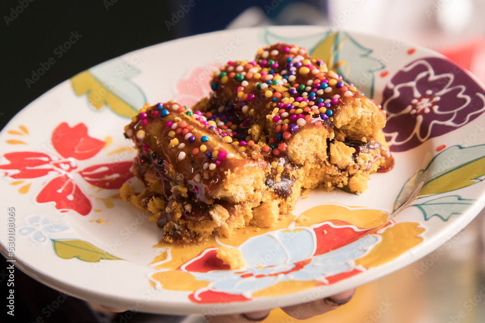 Girl eating Turron dona pepa dough with honey traditional peruvian ...