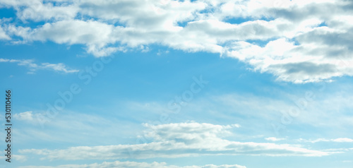 Blue sky with white clouds. Beautiful cloudy sky. Skyward. Endless skyline. The sky at dawn. Banner.