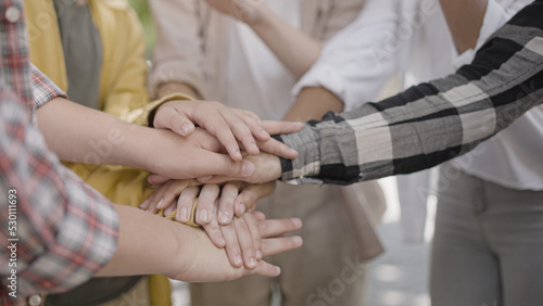 Close-up of teenagers stacking hands, ready to act together, cooperation
