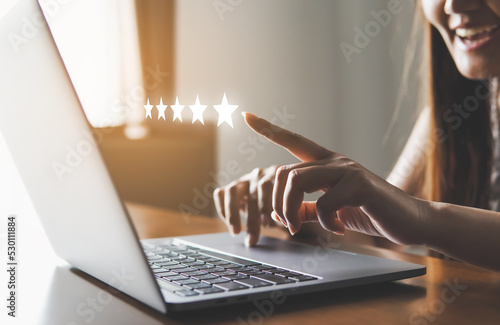 Принти на полотні Customer review good rating concept people use computer laptop and pressing five star rating on visual screen for the positive customer feedback testimonial, five star icon on visual screen