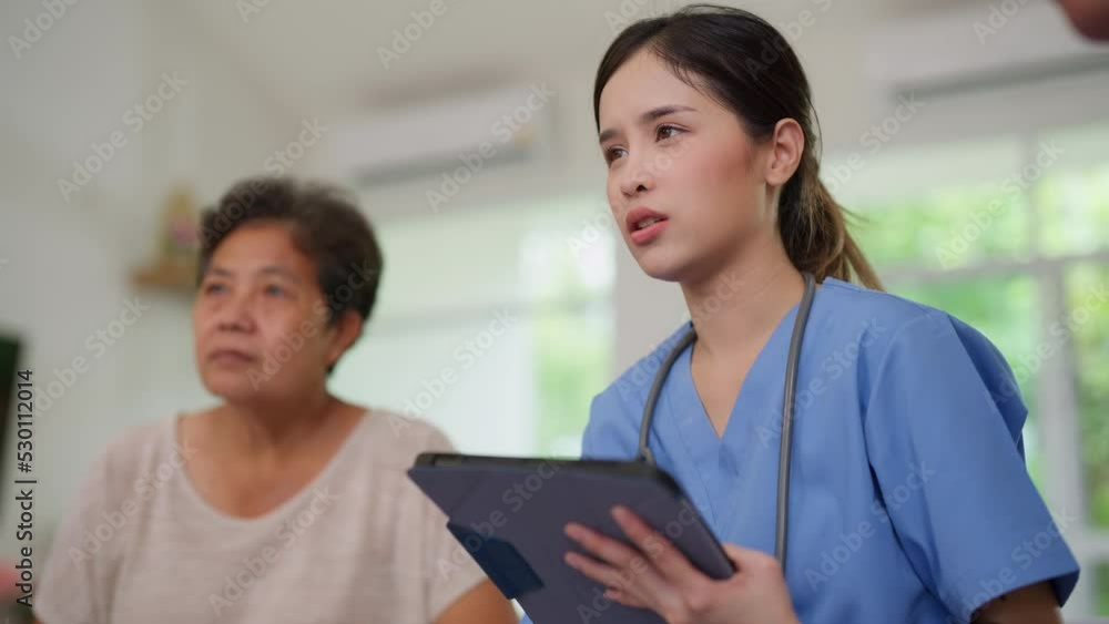 Young female nurse doctor caregiver holding tablet explaining prescription prescribing drug to elderly patient at nursing home. Record check up information. Healthcare pharmacy and insurance service Young female nurse doctor caregiver holding tablet explaining prescription prescribing drug to elderly patient at nursing home. Record check up information. Healthcare pharmacy and insurance service