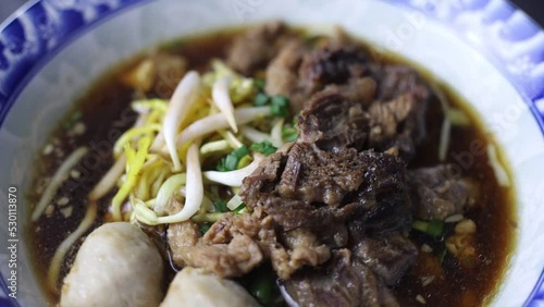 Thai boat noodles is Thailand's most famous noodles soup,Thai Boat noodles soup or Guay tiew reua ,Rice noodles thicken soup with stewed pork and pork ball, Braised pork and liver pork,  photo