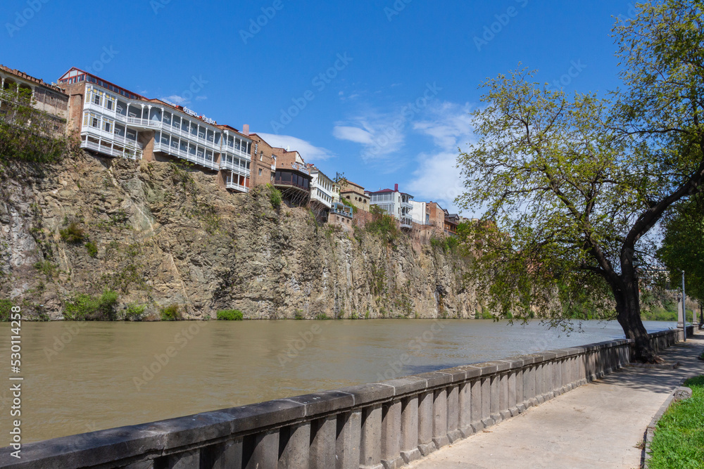 Historic residential buildings on the banks of the steep banks of the Mtkvari River. Georgia country