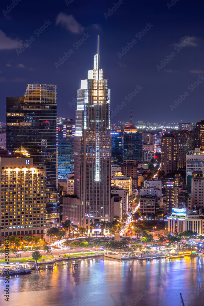 Aerial view of Bitexco Tower, buildings, roads, Thu Thiem 2 bridge and Saigon river in Ho Chi Minh city - Far away is Landmark 81 skyscraper. Travel concept.