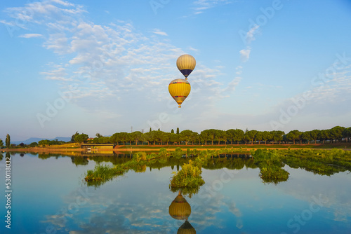 hot-air balloons reflected on the lake