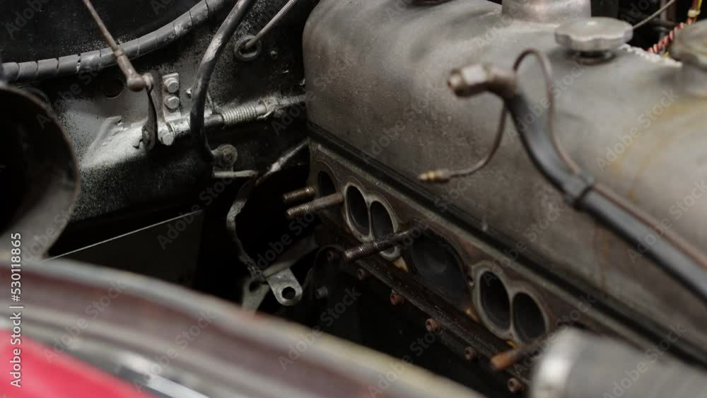 removed exhaust manifold close up view of engine. machine is in process