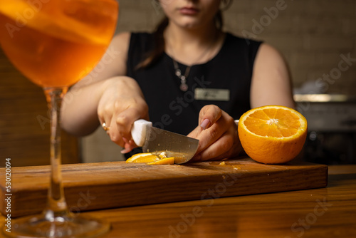 A bartender prepares a cocktail at the restaurant bar 