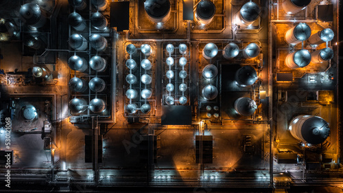 Aerial top view petrochemical tank at night, Oil and gas tank at oil refinery at night, Petrochemical industrial, Refinery factory petrochemical and petroleum at night.