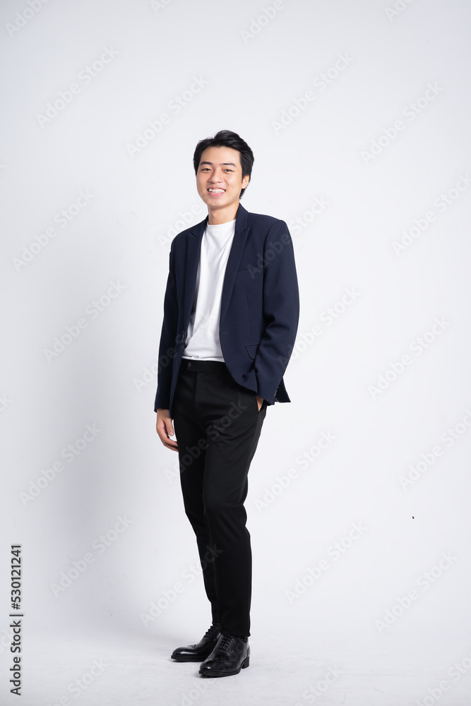 Young business man wearing a suit posing on a white background Young business man wearing a suit posing on a white background