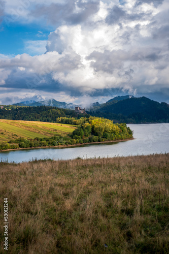View of the Czorsztyn Lake. Castle in Czorsztyn in the background. Beautiful mountain landscape. Lagoon of the Pieniny Landscape Park