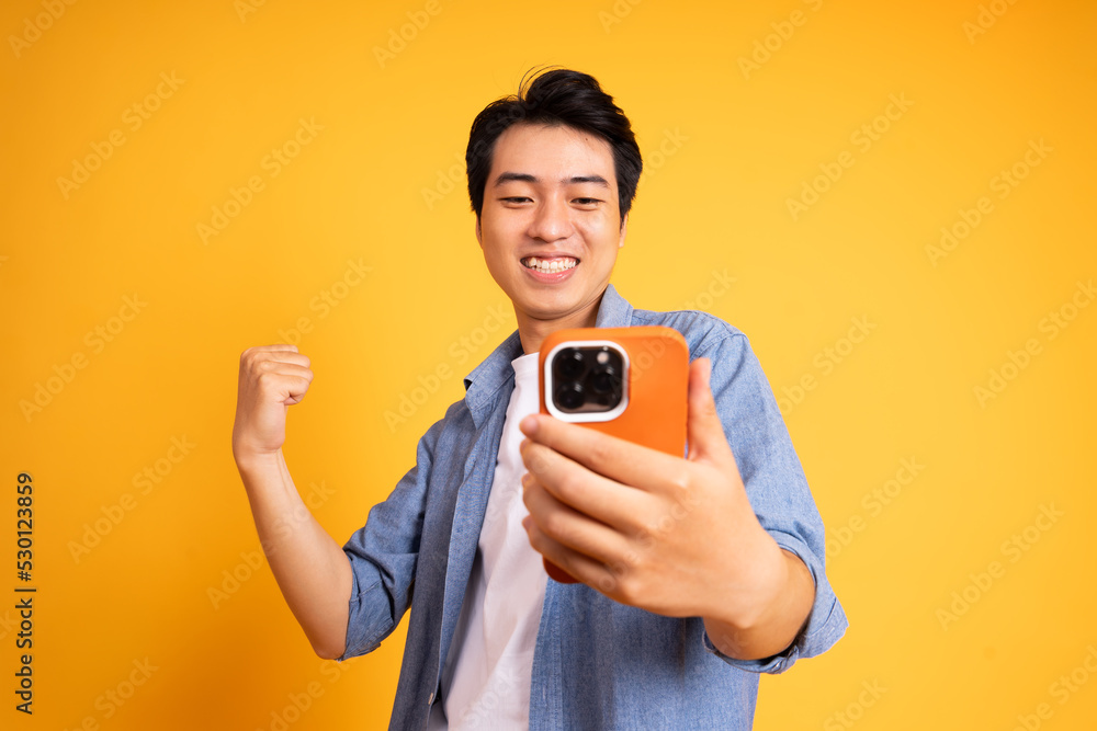 image of asian man posing on a yellow background image of asian man posing on a yellow background