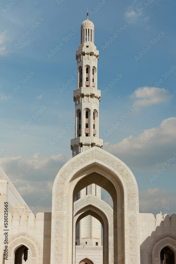 Muscat Sultan Qaboos Mosque building with arch and minaret, Oman