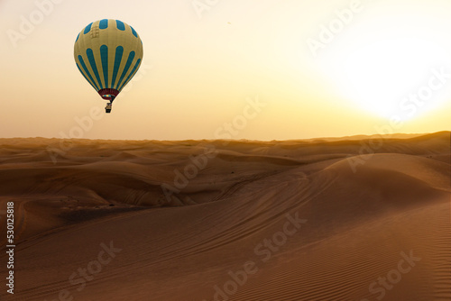 Hot air balloon in sand desert sunset landscape, Dubai, United Arab Emirates