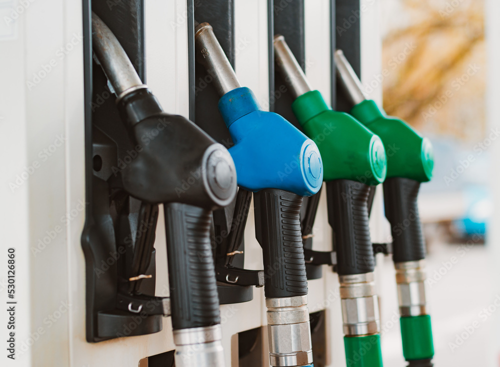 Unrecognizable man refueling car from gas station filling benzine gasoline fuel in car at gas station. Petrol high prices concept Unrecognizable man refueling car from gas station filling benzine gasoline fuel in car at gas station. Petrol high prices concept