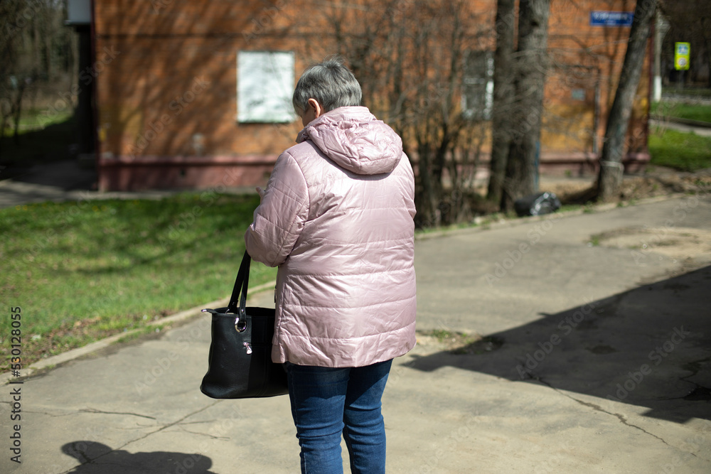 Woman in warm jacket in spring. Woman on street.