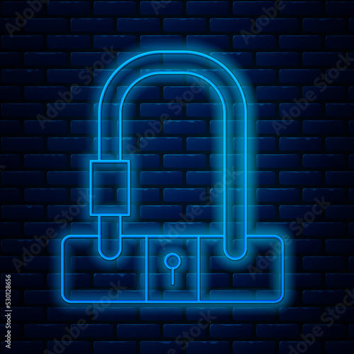 Glowing neon line Bicycle lock U shaped industrial icon isolated on brick wall background. Vector