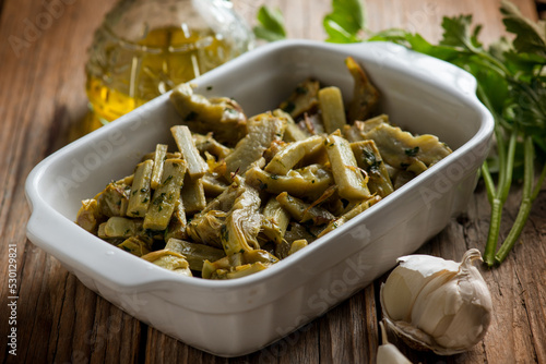 sauteed artichoke with garlic parsley and olive oil #530129821