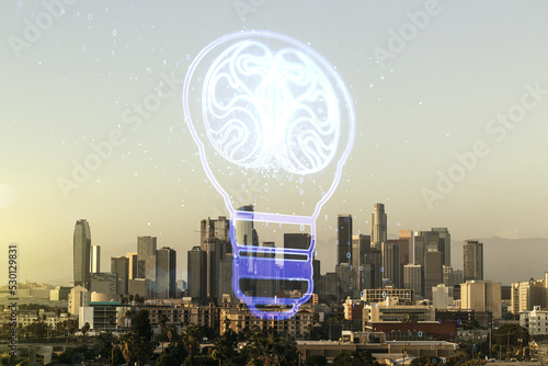 Abstract virtual creative light bulb with human brain hologram on Los Angeles office buildings background, artificial Intelligence and neural networks concept. Multiexposure
