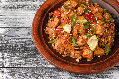 Pilaf with meat, vegetables, chicken. homemade pilaf on a white wooden background