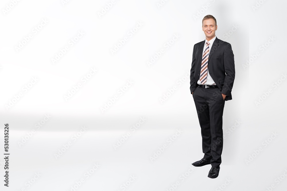 Young businessman standing and posing on background Young businessman standing and posing on background