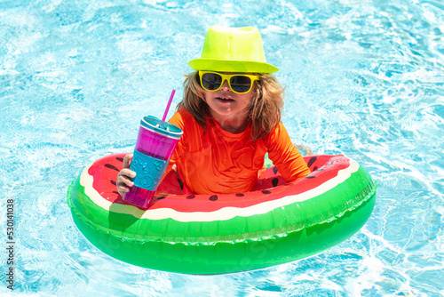 Kid in swimming pool  relax swim on inflatable ring and has fun in water on summer vacation. Kids summer vacation  swimming and relax.