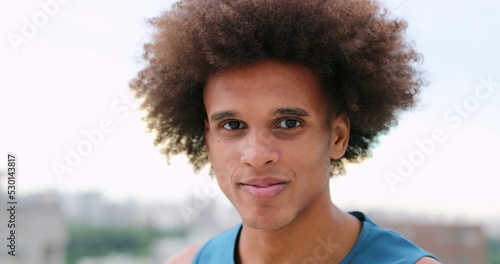 Portrait of mixed race young man smiling and feeling happy. African descent person looking to camera with smile