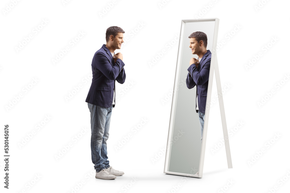 Full length profile shot of a young man getting ready and looking at a mirror - obrazy, fototapety, plakaty 