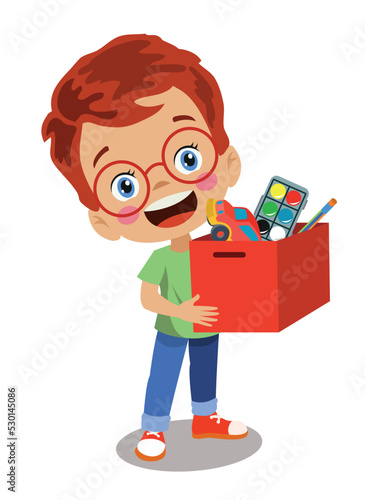 smart boy who collects his toys and stuffs them in the box