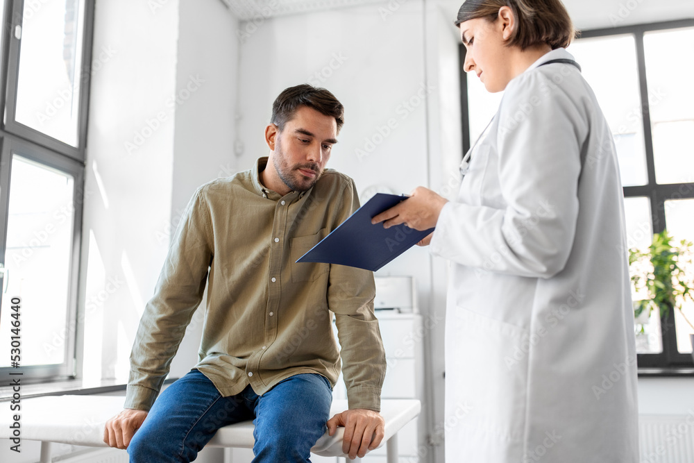 medicine, healthcare and people concept - female doctor with clipboard and male patient having health problem at hospital medicine, healthcare and people concept - female doctor with clipboard and male patient having health problem at hospital