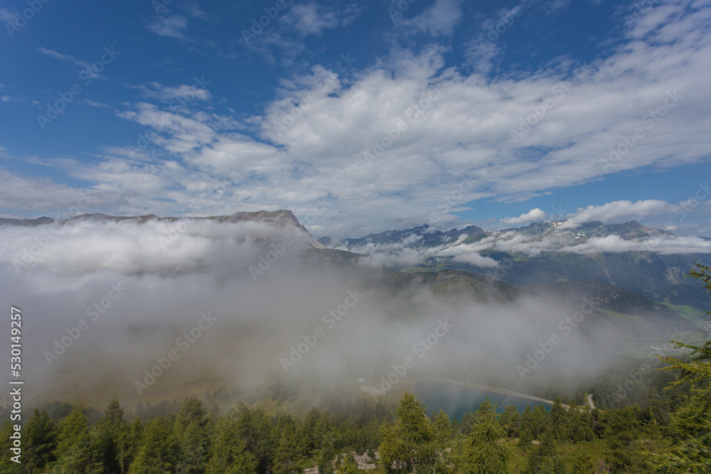 Awesome alpine panorama with clouds on the border between Switzerland, Italy and Austria. Resia Pass, Alto Adige Sudtirol, Italy
