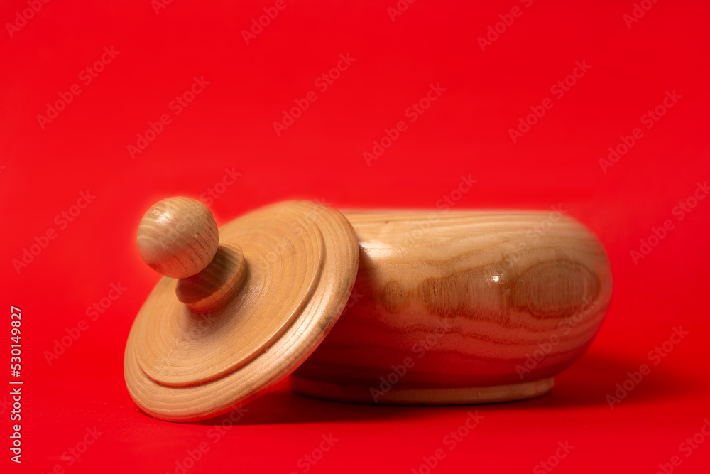 Wooden sugar bowl on a red background Wooden sugar bowl on a red background