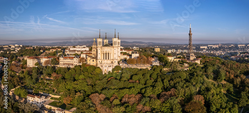 The drone panoramic view of The Basilica of Notre-Dame de Fourvière and Metallic tower on the top of hill, Lyon, France.
