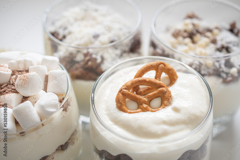 Delicious sweet dessert with cream in a glass on a light background, a beautiful breakfast Delicious sweet dessert with cream in a glass on a light background, a beautiful breakfast