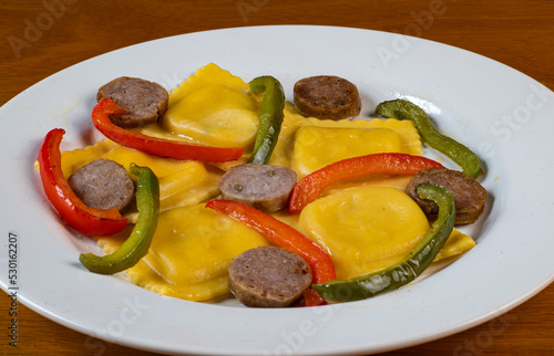 four cheese ravioli  with sweet italain sausage  and peppers photo